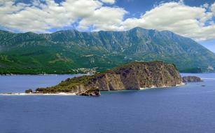 Beautiful landscape with the islands with mountains with colorful plants, under the blue sky with clouds