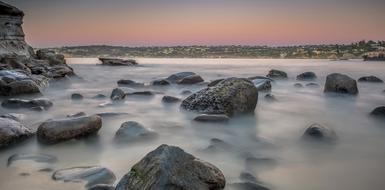 Beautiful, seashore with rocks, at colorful and beautiful, gradient sunset
