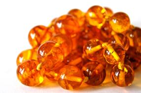 amber beads on a white background