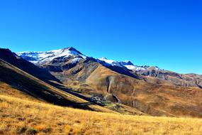 Beautiful and colorful KaÃ§kars mountains with plants and snow, in sunlight, in KaÃ§kars, Turkey, under the blue sky
