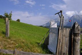 Beautiful landscape with shower, among the colorful plants, on the mountain, under the blue sky with clouds