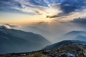 mountain landscape in fog at dusk