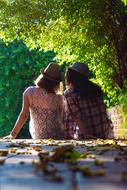 two girls in hats in a picturesque landscape