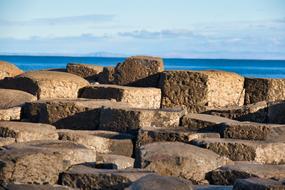 Beautiful landscape of the Giant's Causeway on the coast of the sea in Northern Ireland, under the sky with clouds