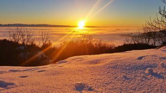 sunset over a shiny snowy landscape