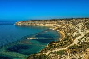 Beautiful and colorful beach with cliffs in Cyprus, under the blue sky