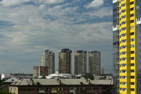 Buildings with windows in Novosibirsk, Russia, under the blue sky with clouds
