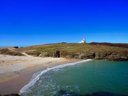 Beautiful and colorful landscape of Belle-Ile-En-Mer, with the lighthouse, in Brittany, France, under the blue sky