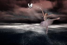 ballerina dancing with a dove at dusk