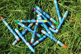 colored crayons on green grass