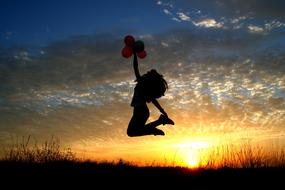 Girl with Balloons silhouette at Sunset