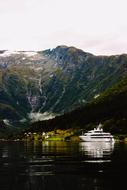Beautiful and colorful landscape of the fjord, with ship on the water, among the mountains in Norway