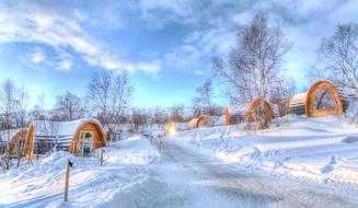 Beautiful, snowy landscape of Kirkenes, Norway, with path among the trees