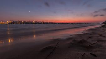 Beautiful landscape of the sandy beach of the Elbe River, with colorful lights, in Hamburg, Germany, at colorful and beautiful, gradient sunset