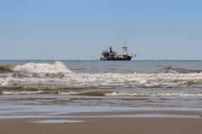 fishing ship at north sea, surf