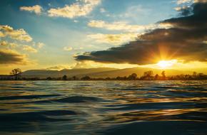 bright sun in the evening sky over the sea