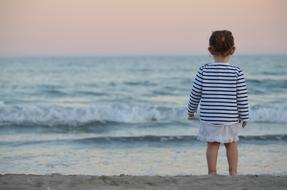 Kid on beach at sunset