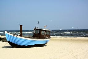 blue boat on the sandy beach