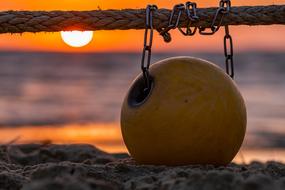 ball on beach at sunset