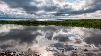 gray clouds are reflected on the sea coast