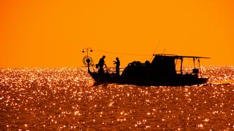 fishing boat against the orange sky, Cyprus