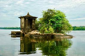 old abandoned building on small island on Lake