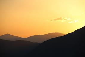 yellow sky over alpine mountains