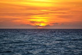 calm evening sea against a yellow sky