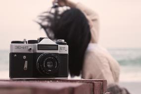 Girl and old Camera by the Sea