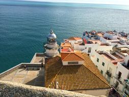 lighthouse and rooftops of buildings in Peniscola, Spain