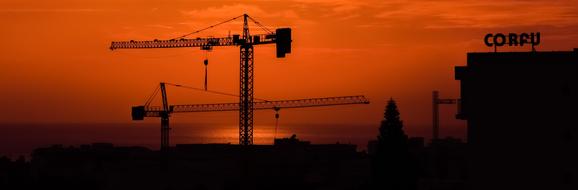 Cranes Construction at Sunset