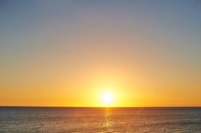 tropical ocean and yellow evening sky on the horizon
