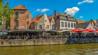 buildings and street restaurants on the waterfront in Bruges, Belgium