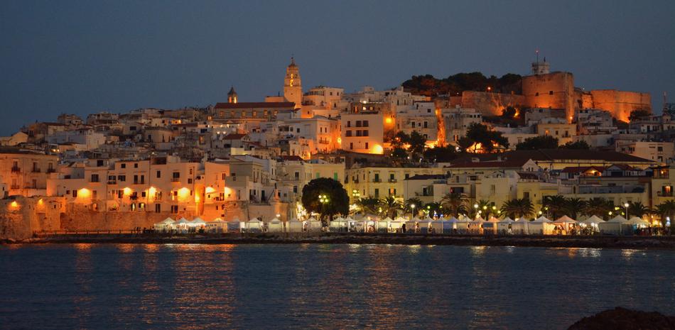 distant view from the water of the city of Vieste at night