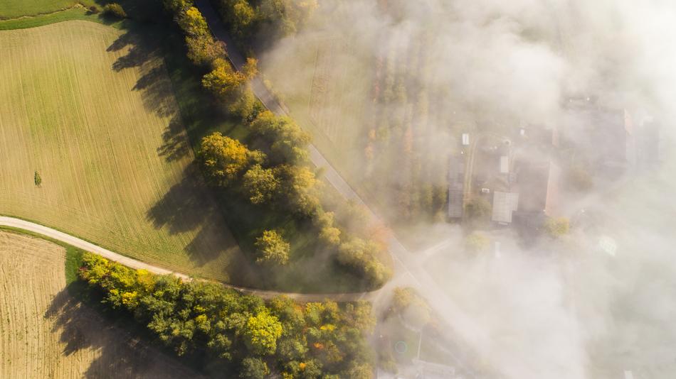 aerial photography of a scenic landscape in the fog