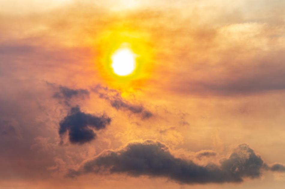 Beautiful and colorful Sun at sunset among the clouds, in the evening