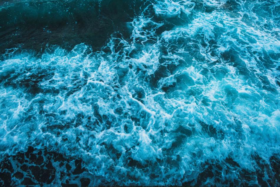 Top view of the sea, with beautiful and colorful waves, in the summer