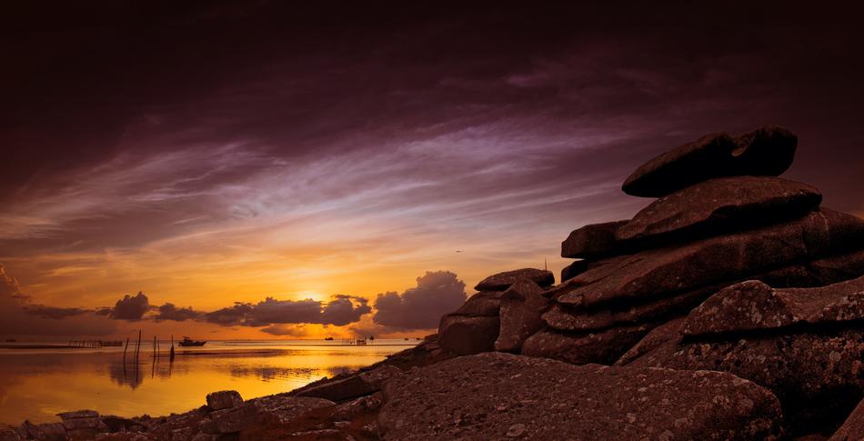 rock formation on the coast at yellow twilight