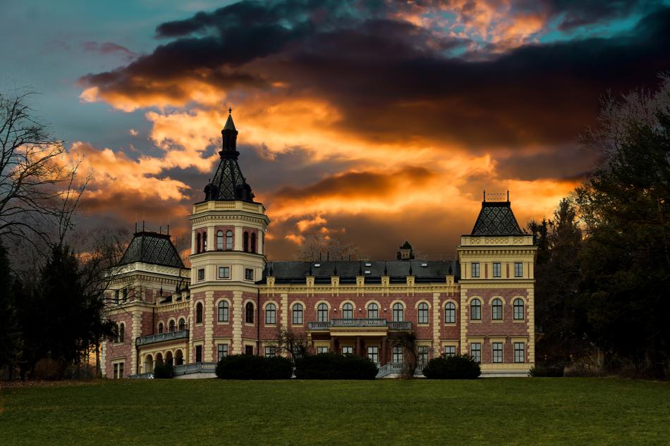 palace with towers on the background of evening clouds