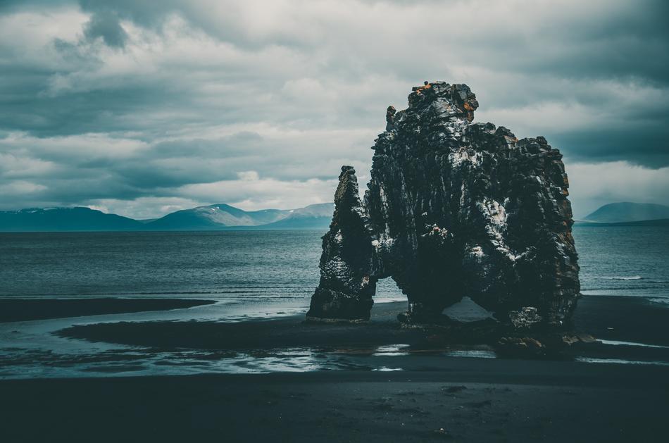 rock on the coast of iceland in dark twilight