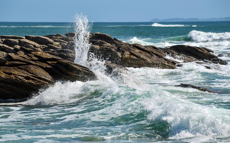 waves with splashes near stones in the sea