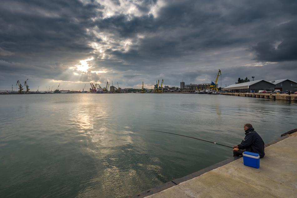 fishing on the coast of the bay on a cloudy day