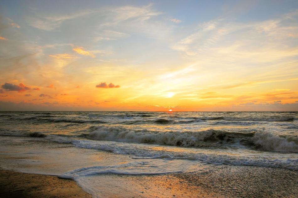 sun over the coast of denmark at dusk
