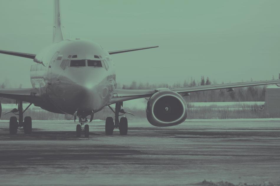 Plane at the airport, near the trees, in green colors