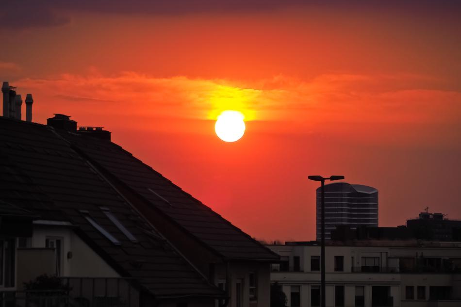Buildings and hill, at colorful and beautiful sunset among the clouds