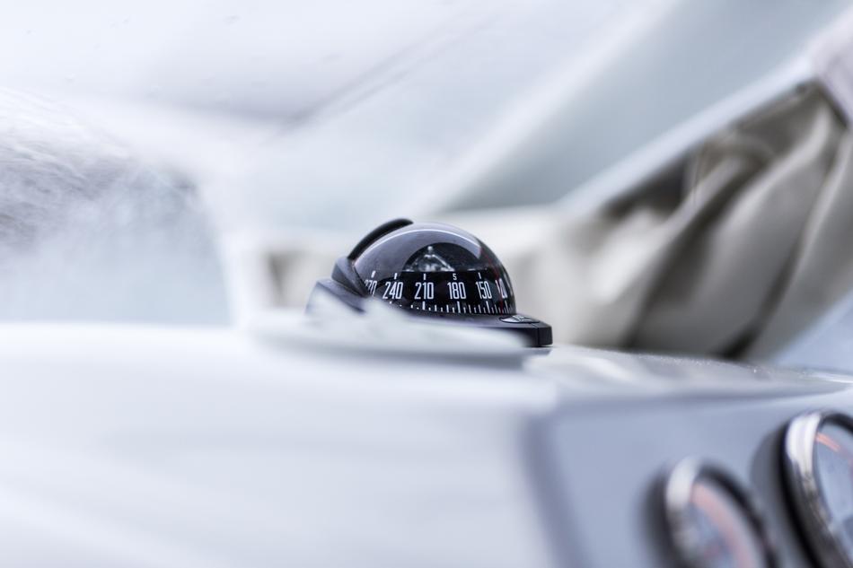 Close-up of the shiny compass on the dash, with numbers