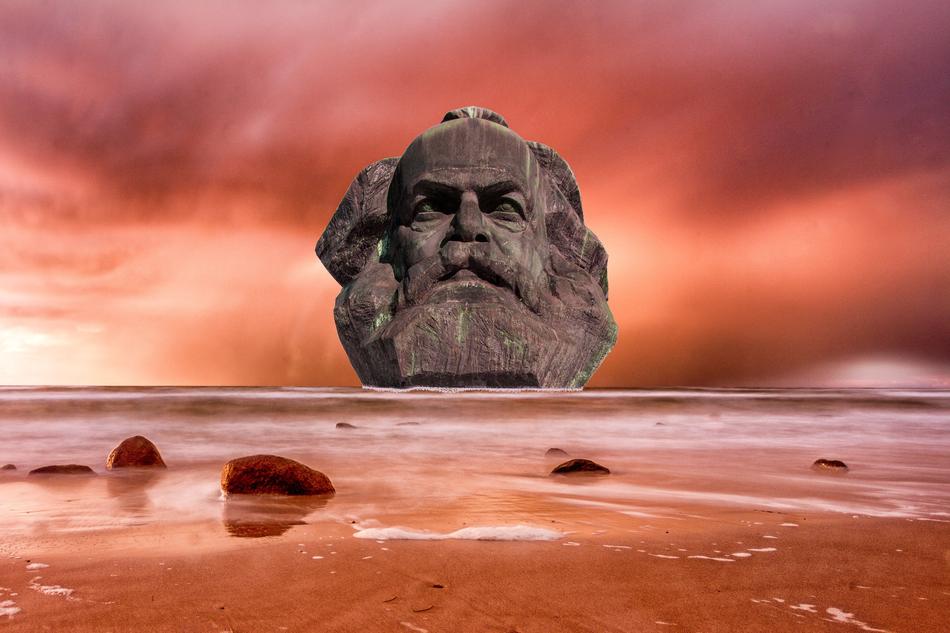 stone head of Marx, beach, pink sky