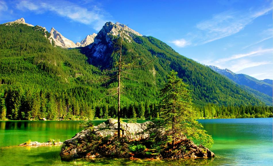 rocky island on the lake against the backdrop of mountains