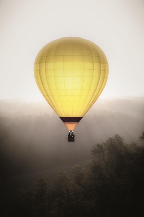 yellow hot air balloon in the fog