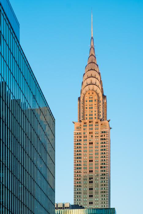 Chrysler Tower near blue glass facade at sky, usa, Manhattan, nyc